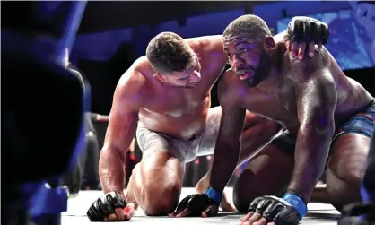  ?? Photograph: Douglas P DeFelice/Getty Images ?? Alistair Overeem (left) consoles Walt Harris at the end of their fight.