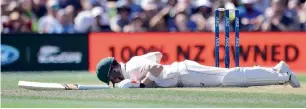  ?? AFP ?? Steve Smith falls to the ground after being hit on the head by a bouncer from Neil Wagner. —