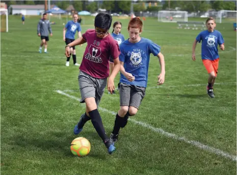  ?? CITIZEN PHOTO BY BRENT BRAATEN ?? Immaculate Conception School’s Jai Singh, left, and Saint Mary’s School’s Cole Sumners jockey for the ball in their game during the eighth annual Terry Wilson Memorial Cup. Twenty-one teams from 11 different schools participat­ed in the Cathloic schools...