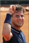  ?? MICHEL EULER — THE ASSOCIATED PRESS ?? Austria’s Dominic Thiem celebrates winning his semifinal match of the French Open tennis tournament against Italy’s Marco Cecchinato in three sets 7-5, 7-6 (12-10), 6-1, at the Roland Garros stadium in Paris, France, Friday.