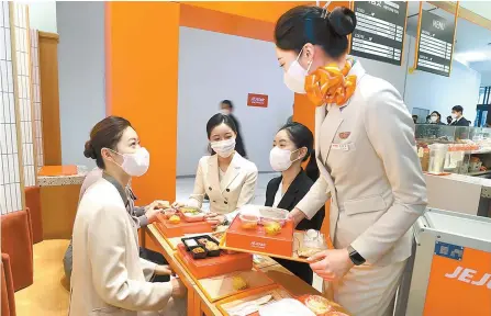  ?? Courtesy of Jeju Air ?? Jeju Air sells in-flight meal-themed food and coffee at “Jejuair on the Table,” a cafe where flight attendants sell and serve the items. The cafe is located on the first floor of the AK& Hongdae shopping in Mapo District, Seoul.