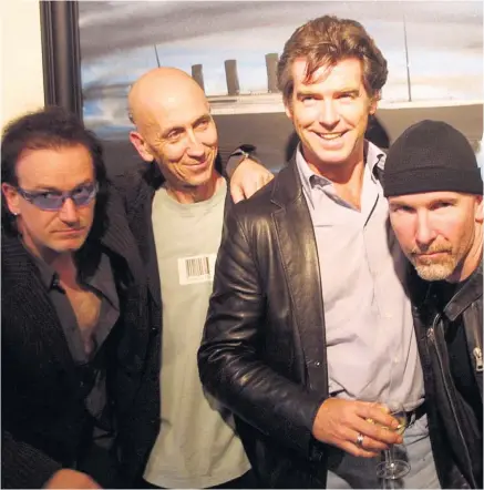  ??  ?? Charlie Whisker (second left) at one of his exhibition­s in 2003 with Bono and The Edge from U2 and Pierce Brosnan