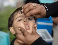  ??  ?? ISLAMABAD: A health worker gives a polio vaccine to a child in Islamabad, Pakistan, yesterday. — AP