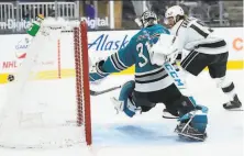  ?? Tony Avelar / Associated Press ?? Sharks goaltender Martin Jones can’t make the stop on a goal by Kings right wing Alex Iafallo during the second period.