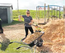  ?? ?? Jery Terekia is busy spreading wood chips, supplied by the truckload, on a playground at Poroutawha­o School.