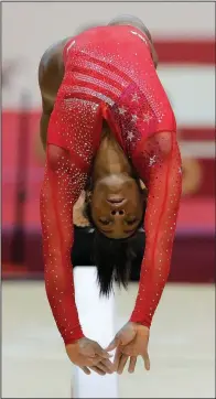  ?? AP/VADIM GHIRDA ?? Simone Biles of the United States performs on the balance beam during the women’s team final of the Gymnastics World Championsh­ips at the Aspire Dome in Doha, Qatar, on Tuesday. The United States won the world championsh­ips by a record 8.766 points.