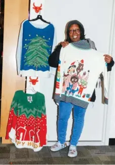  ?? REBECCA SMEYNE/THE NEW YORK TIMES ?? Whoopi Goldberg, in the dressing room for The View, with a selection of ugly Christmas sweaters she designed. They will go on sale Tuesday.