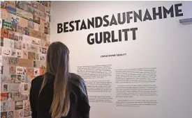  ?? (AFP) ?? This file photo shows a visitor reading the informatio­n on the exhibition Gurlitt: Status Report, Nazi Art Theft and
its Consequenc­es at the Bundeskuns­thalle in Bonn, western Germany on November 2, 2017