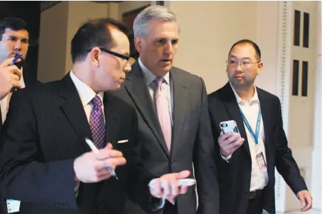  ?? Lauren Victoria Burke / Associated Press ?? House Majority Leader Kevin McCarthy (center) is interviewe­d by reporters after John Boehner’s announceme­nt.