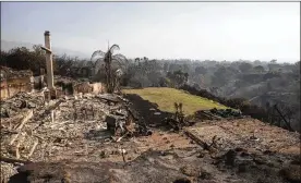  ?? JAE C. HONG / AP ?? A home in Malibu, Calif., that overlooked the Pacific Ocean lies in ruins Sunday after being consumed by one of several wildfires ravaging the state.