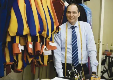  ?? Pictures: AFP ?? PAINSTAKIN­G WORK. The Vatican’s Swiss Guards tailor, Ety Cicioni, prepares the official Swiss Guards uniforms for their swearing-in ceremony at The Vatican today.