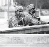  ?? JACQUELINE LARMA/AP ?? National Guard members are posted Sunday near the front of the main entrance to the state Capitol in Harrisburg, Pennsylvan­ia.