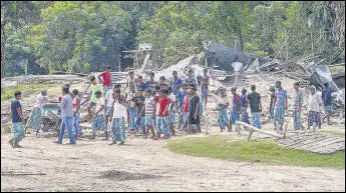  ?? PTI ?? Villagers near their demolished houses in Darrang district.