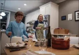  ?? CAROLYN KASTER—ASSOCIATED PRESS ?? Sen. Kirsten Gillibrand, D-N.Y., and her son Henry Gillibrand set the table for dinner in their home in Washington, Tuesday, Feb. 12, 2019.