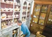  ?? ?? Schiller, 65, works near a cabinet containing dozens of shells and corals for sale.