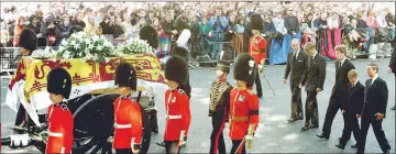  ?? — Reuters file photo ?? Guardsmen escort the coffin of Diana as the cortege passes through crowds gathered along Whitehall, London, on Sept 6, 1997. Walking behind them are the Duke of Edinburgh, Prince William, the Earl of Spencer, Prince Harry and Prince Charles.