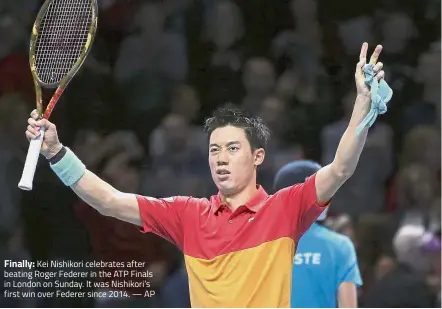  ?? — AP ?? Finally: Kei Nishikori celebrates after beating Roger Federer in the ATP Finals in London on Sunday. It was Nishikori’s first win over Federer since 2014.