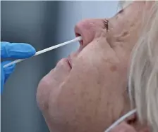  ?? MaTT STONe / heraLD STaFF FILe ?? ON THE NOSE: Nancy DeAngelo of Quincy gets a nose swab at Whittier Street Health Center’s mobile COVID19 testing site at the Washington Park Mall in December. A new symptom is causing normal scents to smell foul.