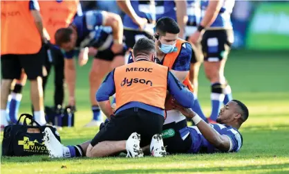  ?? David Rogers/Getty Images ?? Bath’s Anthony Watson receives attention to a strained knee during the Premiershi­p match against Saracens on Sunday. Photograph: