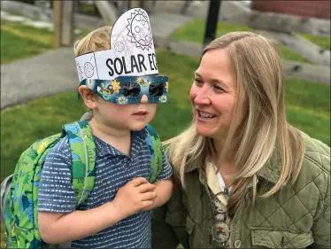  ?? PHOTO BY JEN SAMUEL FOR THE DAILY LOCAL NEWS ?? Leland Boisseau prepares to watch the eclipse with her son Braxton, 3, at Upland in East Marlboroug­h on April 8.