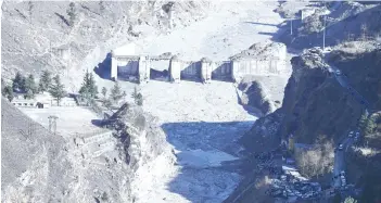  ?? — AFP photos ?? A general view shows the remains of a dam along a river in Tapovan of Chamoli district damaged after a flash flood thought to have been caused when a glacier broke off on Feb 7.