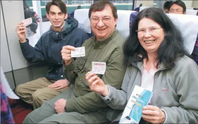  ?? CHENG ZI / FOR CHINA DAILY ?? European passengers proudly show off their high-speed railway tickets during a CRH train ride to Beijing from Tianjin.
