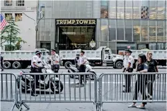  ??  ?? New York Police Department (NYPD) officers stand guard during a rally outside of Trump Tower in New York(bloomberg/jeenah Moon).