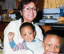  ?? Family photo ?? Aaron Hutcherson is held by his mother, Rita Hutcherson, with his older brother, David, in their kitchen.