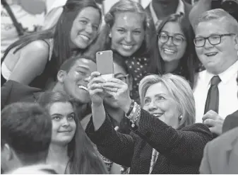  ?? JAY LAPRETE, AP ?? Hillary Clinton takes a selfie with young supporters at Fort Hayes Vocational School in Columbus, Ohio, in June.