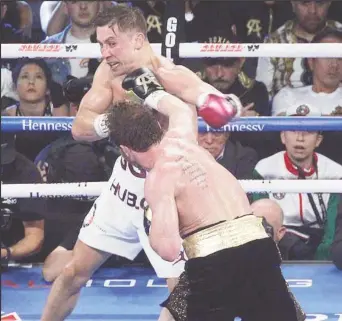  ??  ?? Canelo Alvarez and Gennady Golovkin trade punches during Saturday night’s fight. (Photo courtesy Fightnews website)