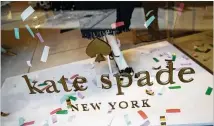  ?? DREW ANGERER / GETTY IMAGES ?? A Kate Spade logo is seen on a Madison Avenue storefront after fashion designer Kate Spade was found dead in her apartment June 5 in New York City. Suicide is now the 10th leading cause of death in this country.