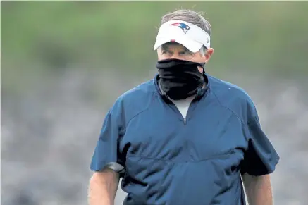  ?? Nancy Lane, Boston Herald ?? Bill Belichick walks on the field during New England Patriots practice at Gillette Stadium on Saturday. Players have praised Belichick for making them a priority amid the COVID- 19 outbreak.
