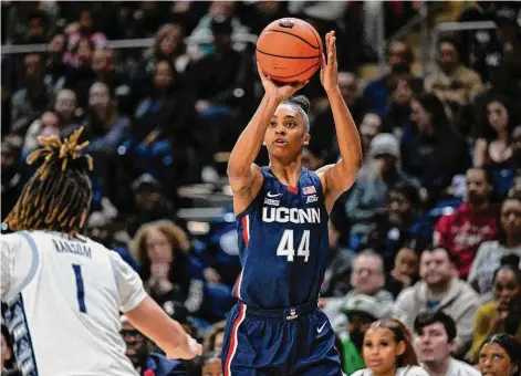  ?? Terrance Williams/Associated Press ?? UConn forward Aubrey Griffin (44) attempts a 3-point basket during the first half of an NCAA college basketball game against Georgetown on Feb. 11 in Washington.