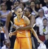  ?? ELAINE THOMPSON — THE ASSOCIATED PRESS ?? Tiffany Hayes, right, playfully puts a bear hug on Diana Taurasi after a foul by Taurasi during the second half of the WNBA All-Star game on Saturday in Seattle.