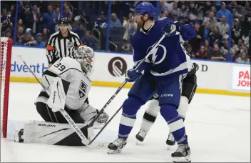  ?? CHRIS O’MEARA – THE ASSOCIATED PRESS ?? Lightning defenseman Nick Perbix scores past Kings goaltender Cam Talbot in overtime Tuesday night in Tampa, Fla.