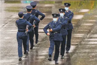  ?? Anthony Wallace / AFP / Getty Images ?? Uniformed officers goosestep in formation, the same style used by police and troops on the Chinese mainland, during celebratio­n of National Security Education Day in Hong Kong.