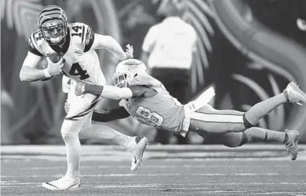  ?? JOHN GRIESHOP/GETTY IMAGES ?? Bengals quarterbac­k Andy Dalton is tackled by Dolphins cornerback Bobby McCain during their game at Paul Brown Stadium in 2016.