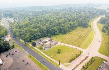  ?? MARK MIRKO/HARTFORD COURANT ?? Nearly 20 acres of forested land bordered by Discovery Drive on the right and Route 44 were purchased recently by the University of Connecticu­t, angering town officials who were interested in developing the area into a multifamil­y housing project.