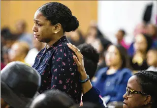 ?? SHABAN ATHUMAN / DALLAS MORNING NEWS ?? Cynthia Johnson, Botham Jean’s girlfriend, stands up as she is comforted by another churchgoer during a prayer service for Jean at the Dallas West Church of Christ on Sunday.
