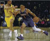  ?? NHAT V. MEYER — BAY AREA NEWS GROUP, FILE ?? The Suns’ Devin Booker (1) dribbles against the Warriors’ Klay Thompson (11) in the fourth quarter of their March 2019 game at Oracle Arena in Oakland.