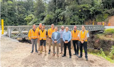  ?? PHOTO / SUPPLIED ?? Western Bay of Plenty mayor James Denyer, deputy mayor John Scrimgeour, council transporta­tion manager Jim Paterson (far right), and key contractor­s and engineers in front of the completed No 4 Road Bailey bridge.