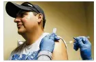  ?? RICARDO B. BRAZZIELL / AMERICAN-STATESMAN ?? Licensed vocational nurse Cynthia Smith gives Willie Chavez a flu shot last month at the South Austin Regional Clinic. State officials say the flu season hasn’t peaked.