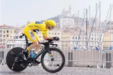  ?? CLAUDE PARIS/ASSOCIATED PRESS ?? Chris Froome, wearing the overall leader’s yellow jersey, competes in the 20th stage of the Tour de France on Saturday. Today he rides in the procession­al final stage.