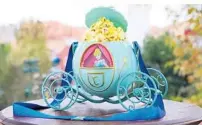  ??  ?? Collectibl­e popcorn containers, such as this one based on Cinderella’s carriage, are gaining popularity.