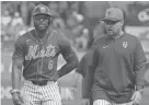  ?? JIM RASSOL/USA TODAY SPORTS ?? Mets right fielder Starling Marte (6) and manager Carlos Mendoza walk back to the dugout after Marte was called out for interferen­ce in the first inning on Sunday against the Houston Astros at Clover Park in Port St. Lucie, Fla.