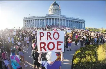  ?? Rick Bowmer Associated Press ?? PEOPLE ATTEND an abortion rights rally at the Utah Capitol in Salt Lake City in June after the U.S. Supreme Court reversed Roe vs. Wade. Lawmakers have since tried several times to restrict or ban abortion.