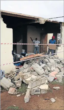  ?? Picture: WERNER HILLS ?? REDUCED TO RUBBLE: Neighbours help out after a truck crashed into this house in Motherwell yesterday