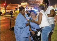  ?? MATTHEW HINTON / THE ADVOCATE VIA AP ?? People react at the scene of a shooting in New Orleans on Saturday night. Police responding to the scene found three victims — two men and one woman — who were pronounced dead at the scene.