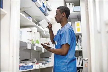  ?? Photo: Sigur Már Karlsson/heimsmyndi­r & Bhekisisa ?? Mind the gap: A healthcare worker does an inventory of available medicine (above). The South African Health Products Regulatory Authority’s Dr Boitumelo Semete (below) says they are ‘understaff­ed and underfunde­d’.