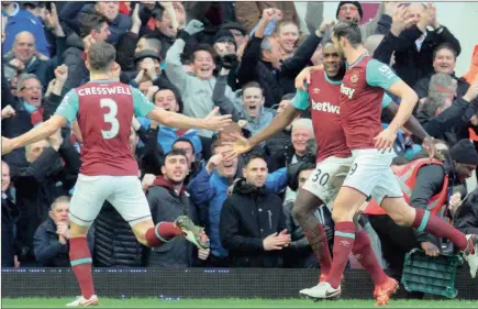  ?? Picture: EPA ?? GOALSCORER­S: West Ham’s Michail Antonio, centre, celebrates with teammate Andy Carroll, right, after scoring in the English Premier League match against Liverpool at Upton Park in London. The Hammers won 2-0, with Carroll scoring the other goal for the...